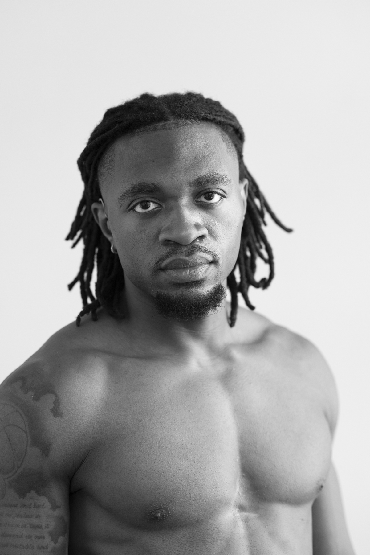 Black-and-white upper-body hero portrait of Enow Otto Jr